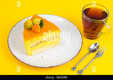 Pezzo di torta di mousse luminoso su sfondo giallo. Foto Studio Foto Stock