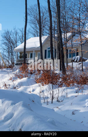 Snowy rurale scena con casa gialla. Scena invernale nel mese di dicembre in Quebec, Canada Foto Stock