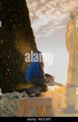 Lo scultore taglia il ghiaccio la figura di Santa Claus per Natale da una motosega ice Foto Stock