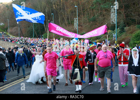 South Queensferry. Edimburgo. La Scozia. Il 1 gennaio 2019. UK.Il Loony Dook continua il suo primo giorno del nuovo anno la tradizione a Edimburgo di Hogmanay. All'ombra del Forth Bridge, i campionatori a immersione in costume di raccogliere fondi per beneficenza. Dookers marzo la lunghezza di South Queensferry High Street guidato dal rumore batteristi del Comitato come parte dell'Dookers' Parade. Edimburgo. Credito: pak@ Mera/Alamy Live News Foto Stock