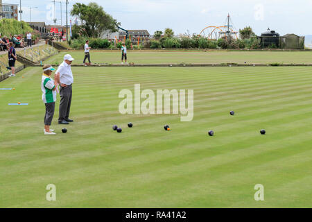 Outdoor torneo di bocce di essere riprodotti su una giornata d'estate, a Hunstanton Cliff Parade WBA bowls club. Hunstanton, Norfolk, Inghilterra, Regno Unito Foto Stock