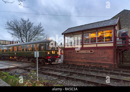 Anni sessanta diesel multiple uint treno. Sera d'inverno a Ramsbottom stazione sulla East Lancashire Railway. La casella segnale. Foto Stock