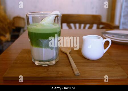 Il tè verde Afogato latte sulla tavola di legno al cafe Foto Stock