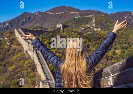 Felice allegro gioioso donna turistico presso la Grande Muraglia della Cina divertirsi sul viaggio sorridente ridendo e ballando durante il viaggio in Asia. Ragazza la visita e gita destinazione cinese Foto Stock