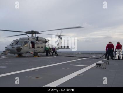 Sul mare del sud della Cina (GEN. 31, 2017) marinai a bordo Littoral Combat Ship USS Coronado (LCS 4) La condotta di una pompa a caldo, il rifornimento di carburante un MH-60S Sea Hawk elicottero durante il volo trimestri. Attualmente su una distribuzione di rotazione a sostegno del ribilanciamento Asia-Pacifico, Coronado è un veloce ed agile nave da guerra fatta su misura per pattugliare le acque della regione marine e lavoro carena e scafo con partner marine, fornendo 7 flotta con le funzionalità flessibili di cui ha bisogno ora e in futuro. Foto Stock