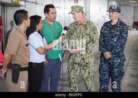 (Feb. 1, 2017) puerto BARRIOS - Capt. Errin Armstrong, comandante della missione per continuare la promessa 2017 (CP-17), e il tenente La Cmdr. Robert Lennon, CP-17's medical officer in carica, parlare con un cavo locale news reporter durante un CP-17 evento mediatico in Puerto Barrios, Guatemala. CP-17 è un U.S. Comando sud-sponsorizzato e U.S. Forze Navali Comando meridionale/STATI UNITI 4a flotta-condotto di distribuzione condotta civile-militare comprendente le operazioni di assistenza umanitaria, impegni di formazione e medico, dentista e supporto di veterinari in uno sforzo per mostrare il supporto degli Stati Uniti e di impegno per il centro e sud Amer Foto Stock