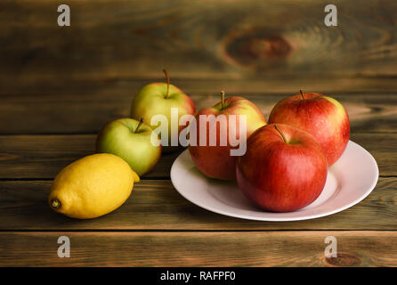 Natura morta con mele e succo di limone su una tavola di legno tavolo rustico Foto Stock