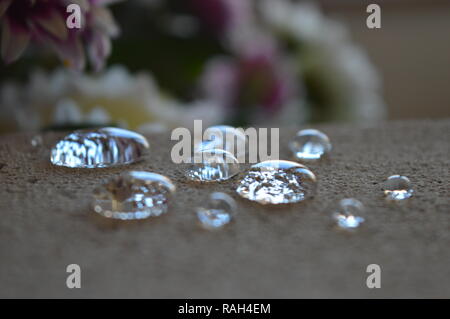Minuscole goccioline di acqua su una superficie di cemento Foto Stock