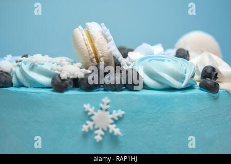 Il simbolo del fiocco di neve bianca sulla torta. Torta decorata con marshmallow, zaphyr e bacche. Inverno torta ricoperta con mastice di blu. Torta sfondo per vacanze invernali Foto Stock