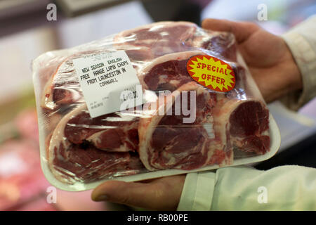 Macelleria preparare carne in vendita nel loro negozio all'ingrosso in Smithfield nella città di Londra. Feb 2013. Foto Stock