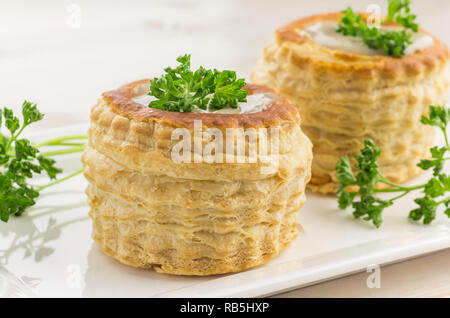 Pane appena sfornato, vol-au-vent con ripieno di funghi, guarnita con prezzemolo Foto Stock