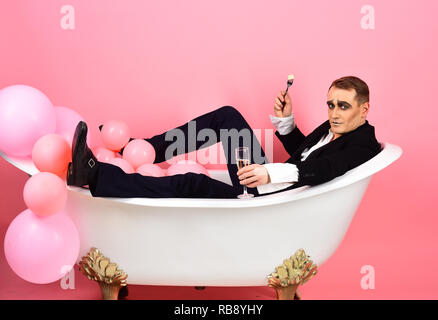 Sto celebrando. Attore Mime godetevi il bagno nella vasca da bagno. La balneazione e rilassante. Mime è l'uomo festa con cibi e bevande. Attore comico celebrare le feste. Felice bolla bagno giorno Foto Stock