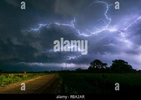 Il fulmine rami tra le nuvole di un temporale del Nebraska. Bella cingolato di incudine fulmine sul retro di un forte temporale complessa. Foto Stock