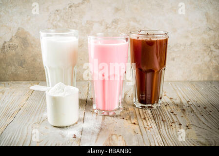 Sana dieta organici bere. Cioccolato, berry e vaniglia protein shake. Non proteina da latte vegan cocktail. Con nastro di misurazione. Concetto di peso los Foto Stock