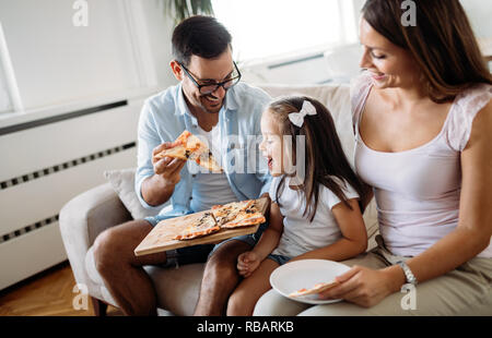 Ritratto di famiglia felice condivisione la pizza a casa Foto Stock