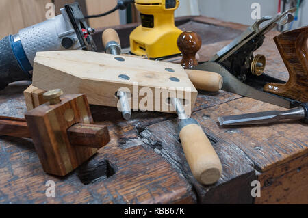 Assortimento di utensili per la lavorazione del legno su un banco di lavoro di antiquariato. Foto Stock
