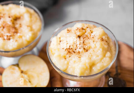 Latte di riso pudding con cannella e mele. Budino di riso vicino fino .gustoso comfort food desert Foto Stock