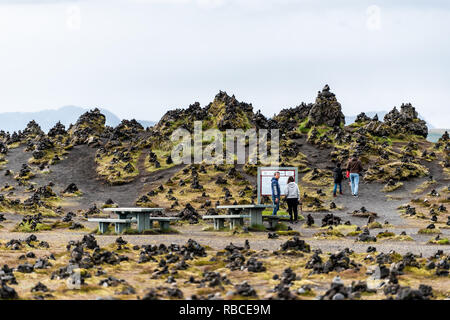 Laufscalavarda, Islanda - 14 Giugno 2018: vista del paesaggio di montagne e di roccia di pietra cairns con persone di turisti asiatici la lettura di informazioni di segno da picn Foto Stock