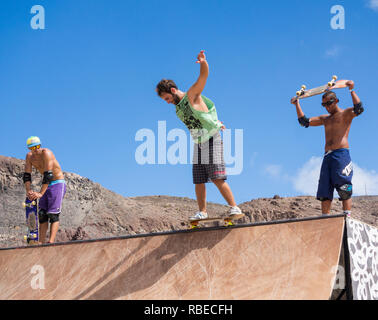 Guidatore di skateboard sulla rampa di skateboard in skatepark. Foto Stock