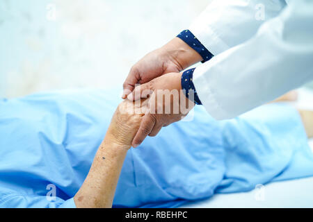 Tenendo la mano Asian senior o anziani old Lady paziente con amore, cura, incoraggiare e di empatia. Foto Stock