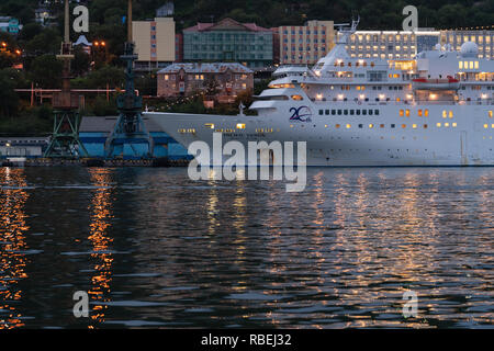 Vista notturna di giapponese crociera Pacific Venus ancorato al molo in mare commerciale porto di Petropavlovsk-Kamchatsky City Foto Stock