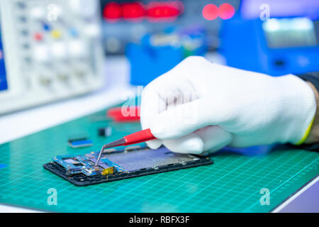 Telefono cellulare riparazione. Tecnico elettronico riparazioni Foto Stock