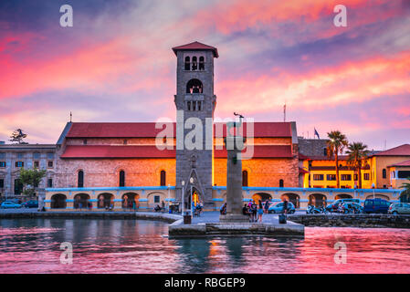 Rhodes, Grecia. Incredibile tramonto immagine Mandraki Harbour e Evaggelismos chiesa il luogo del Colosso di Rodi. Foto Stock