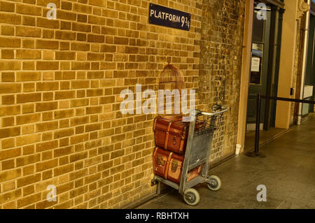 Londra, Regno Unito, Giugno 2018. La piattaforma 9 e 3/4 presso la stazione di Kings Cross, London. Un Trolley bloccato nel muro dove gli appassionati di emulare il Harry Potter a Foto Stock