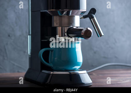 Preparazione di un espresso. Versa il caffè dalla macchina da caffè nella tazza. Professional per l'infusione di caffè a casa Foto Stock