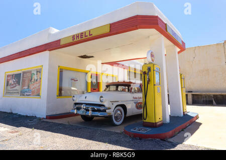 Lowell, AZ, Stati Uniti d'America / Luglio 12. 2016: la vecchia pompa carburante e auto classica ad un abbandono della città fantasma stazione di gas vicino a Bisbee nel deserto dell'Arizona Foto Stock