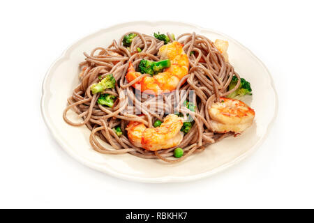 Un piatto di soba, Tagliatelle di grano saraceno con gamberi e verdure, su sfondo bianco con un posto per il testo Foto Stock