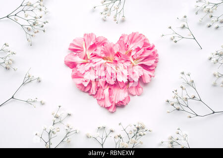 Forma di cuore fatta di Fiori su fondo bianco.Flat laici. Valentines,l'amore e il concetto di matrimonio idee Foto Stock