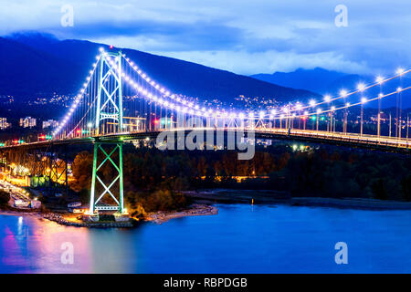 Una vista del Ponte Lions Gate di notte con i riflessi della luce in ingresso Barrard. Foto Stock