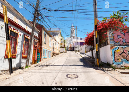 Cercando in salita in un colorato empty street a Valparaiso, Cile. Foto Stock