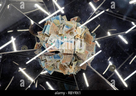 Un mucchio di sterlina inglese carta e denaro di polimero £5 e £10 di banconote in un cassetto di raccolta con riflessi di luce a Londra REGNO UNITO KATHY DEWITT Foto Stock