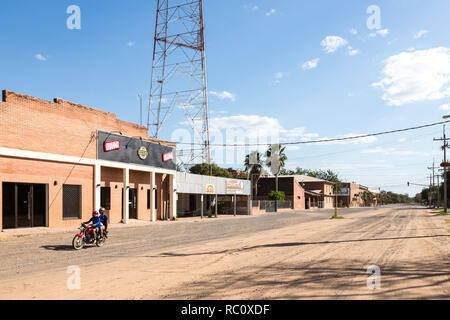 Dal centro città di Filadelfia, Boqueron Affitto Reparto, Gran Chaco, Paraguay. Deutsch mennonita colonia. Due ragazzi su una bici la guida verso il basso la sabbia strada polverosa Foto Stock