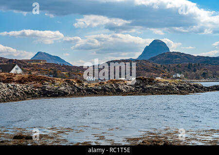 Famosa vista sul Loch Inver verso Canisp (sinistra) e Suilven (destra) con Lochinver attraverso bay in Assynt Highland Scozia UK Foto Stock