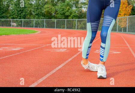 Donna gambe inciampando sul run via durante il funzionamento Foto Stock