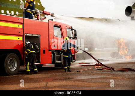 Addestramento vigili del fuoco, la spruzzatura di acqua dal motore Fire a simulazioni di motore aereo Foto Stock