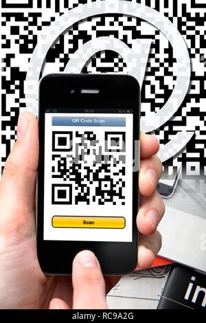Il codice QR-code reader, Quick Codice di risposta, la lettura di un codice QR con uno smartphone e iPhone Foto Stock