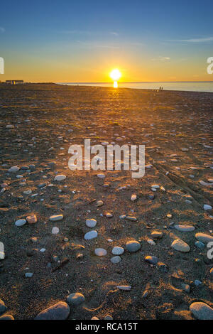 Tramonto sulla spiaggia di ciottoli di Batumi, Georgia Foto Stock