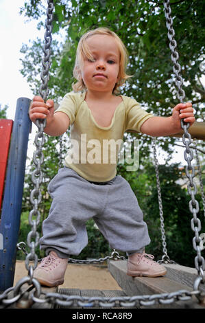 Kleines tipo, Mädchen, 2 Jahre alt, auf dem Spielplatz | piccolo bambino, 2 anni, su un parco giochi Foto Stock