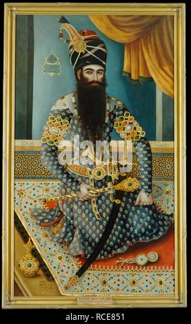 Fath 'Ali Shah. 1798-1799. Fath 'Ali Shah, re di Persia 1797-1834. La Shah è rappresentato seduto su una ricca moquette, indossando un raccordo stretto costume blu fittamente ornata di gioielli. Olio su tela. Originariamente pubblicato/prodotto in 1798-1799. . Fonte: Foster 116. Autore: Baba, Mirza. Foto Stock