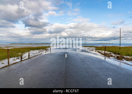 Strada allagata tra Beal e il Santo Isola di Lindisfarne in Northumberland, England, Regno Unito Foto Stock