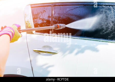 Usando una spazzola per lavare un auto in macchina su un impianto di  lavaggio su soleggiate giornate estive Foto stock - Alamy