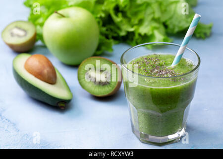 Green frullati in un barattolo di vetro con verdure fresche ed erbe: broccoli, avocado, calce, sedano, mele, kiwi, prezzemolo. detox frullati Foto Stock