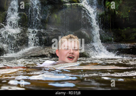 Ragazzo adolescente wild nuotare nel fiume, Rawthey, Yorkshire Dales, UK. Foto Stock