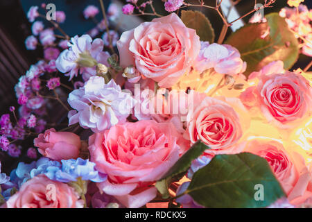 Peonia rose e fiori di piccole dimensioni con un inner glow. Fiore bellissimo sfondo di close-up Foto Stock