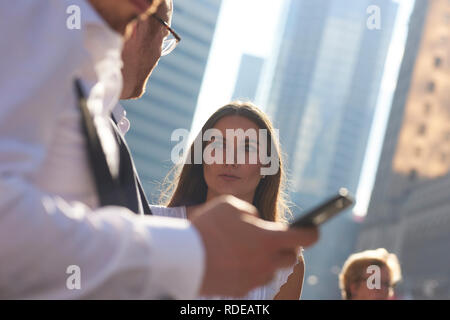Un gruppo di maschio e femmina business partner per discutere di un progetto sulle strade di Toronto nel quartiere business di sole estivo Foto Stock