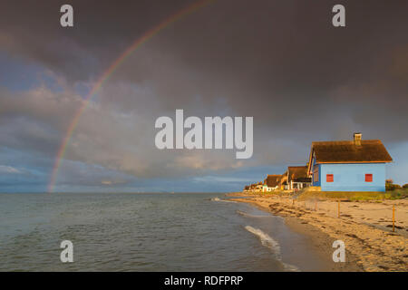 Rainbow e case sulla spiaggia sulla penisola Graswarder, Heiligenhafen, Schleswig-Holstein, Germania Foto Stock